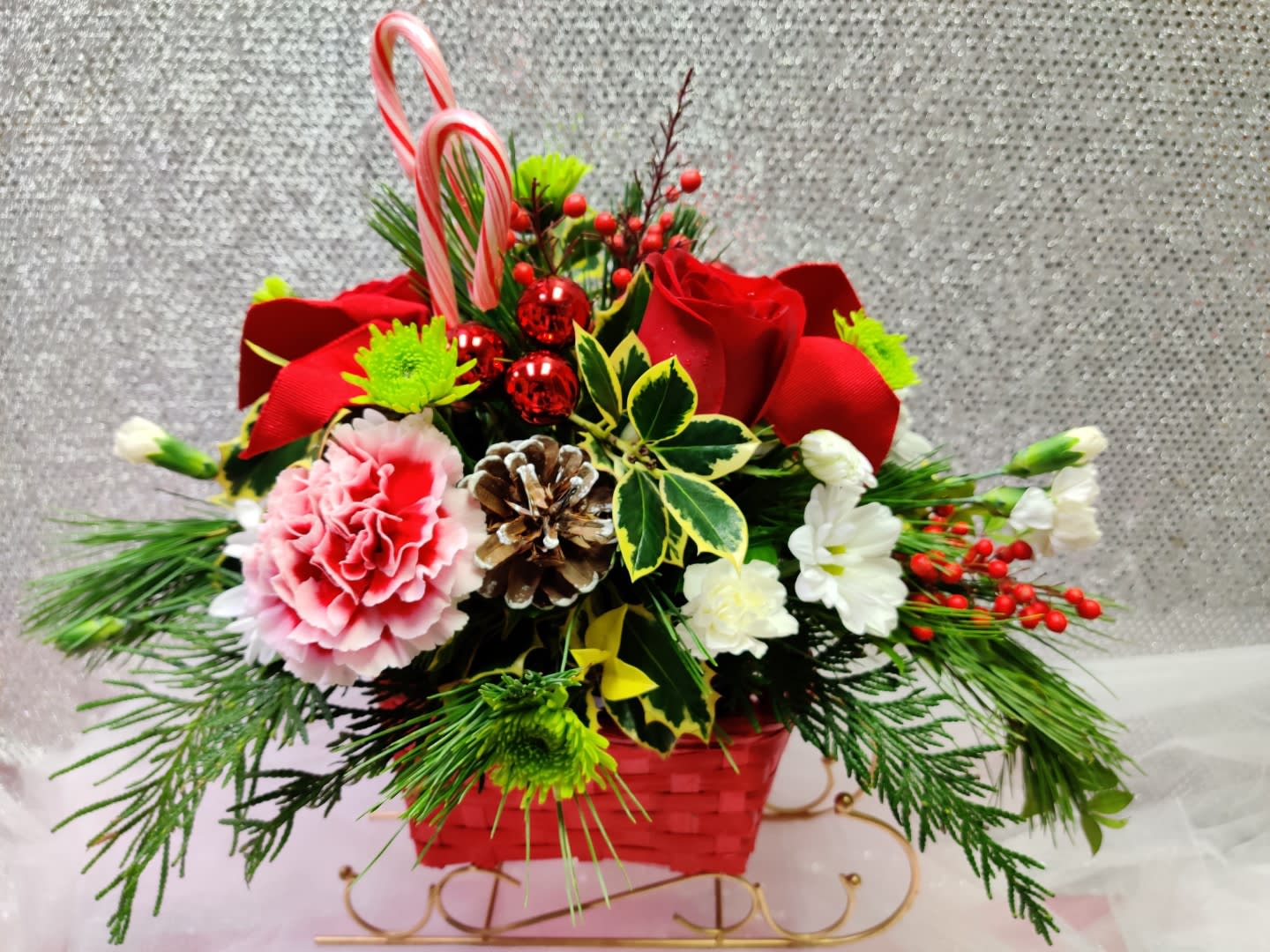 Christmas Sleigh - Contains Roses, Carnations, Poms, Evergreen, Candy Cane and Ornaments.