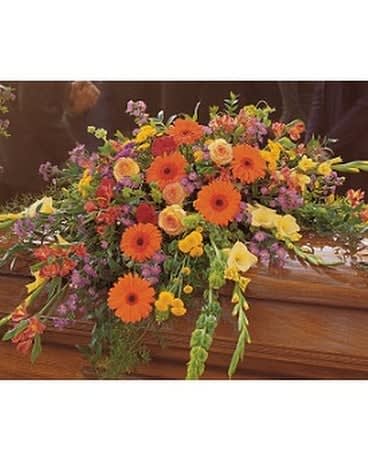 Summer Sentiments Casket Spray Summer Sentiments Casket Spray - Express your warmest sentiments with this colorful spray of summer's brightest blooms. Each casket spray is decorated with red carnations, yellow gladioli, orange gerberas, purple Monte Cassino asters and roses with soft foliages. Approximately 51" W x 38" H Orientation: All-Around As Shown : TF203-2