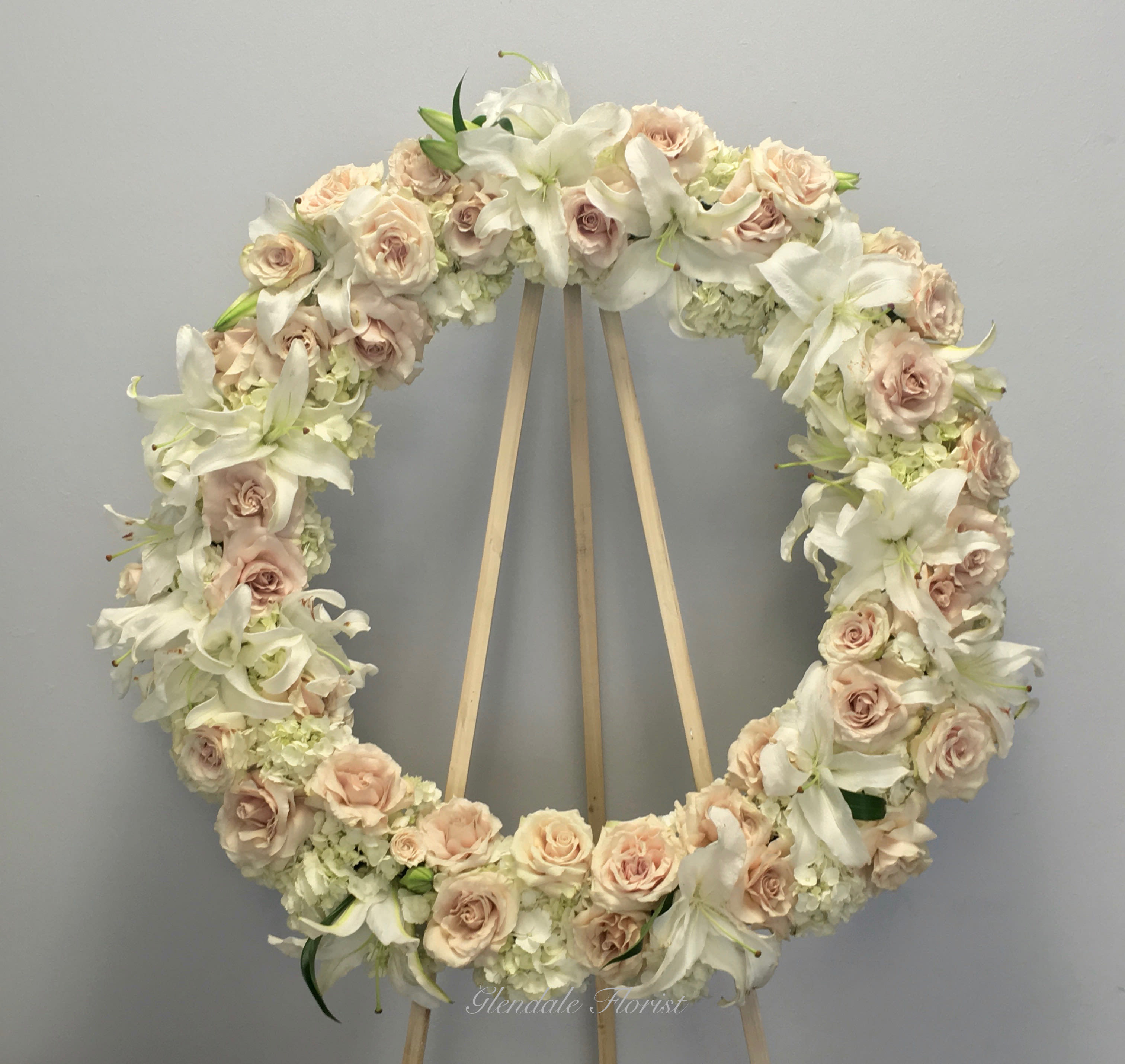 All White Wreath - All White roses, hydrangeas, orchids, and lilies.   We include easel, printed banner and delivery (some fees may apply).  Standard size is 30'', deluxe is 36'', and premium is 42''. 