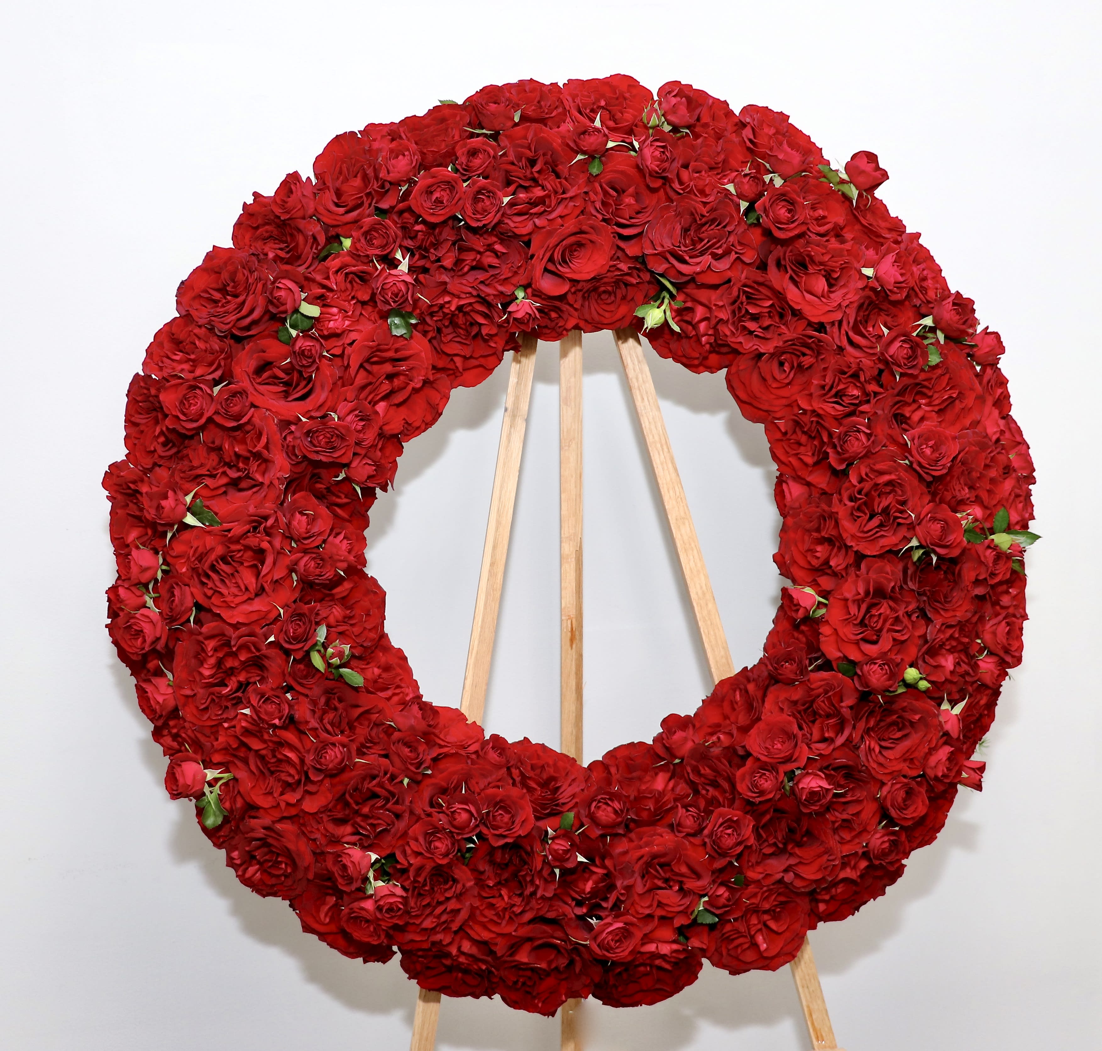Red Rose Wonder Wreath - This wreath includes premium Ecuadorian red roses.  We include easel, printed banner and delivery (some fees may apply).  Standard size is 30'', deluxe is 36'', and premium is 42''.