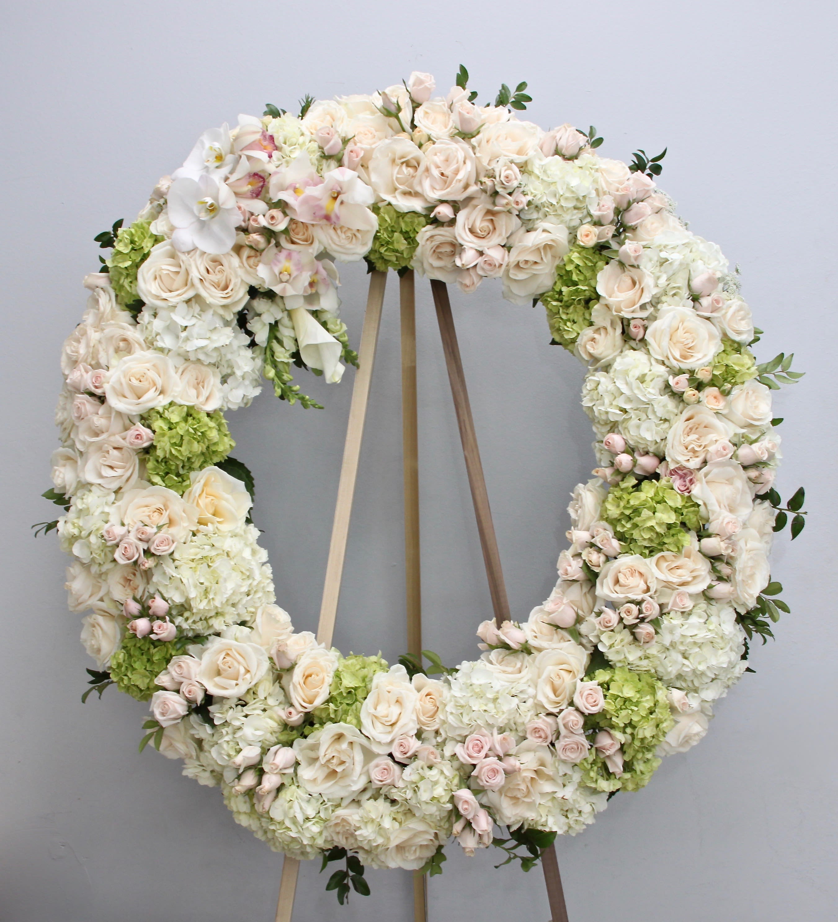 Blush Pink Wreath  - Covered in whites, greens, and pinks, this wreath is approximately 30 inches wide for standard, 36 inches wide for deluxe, and 42 inches wide for premium.   