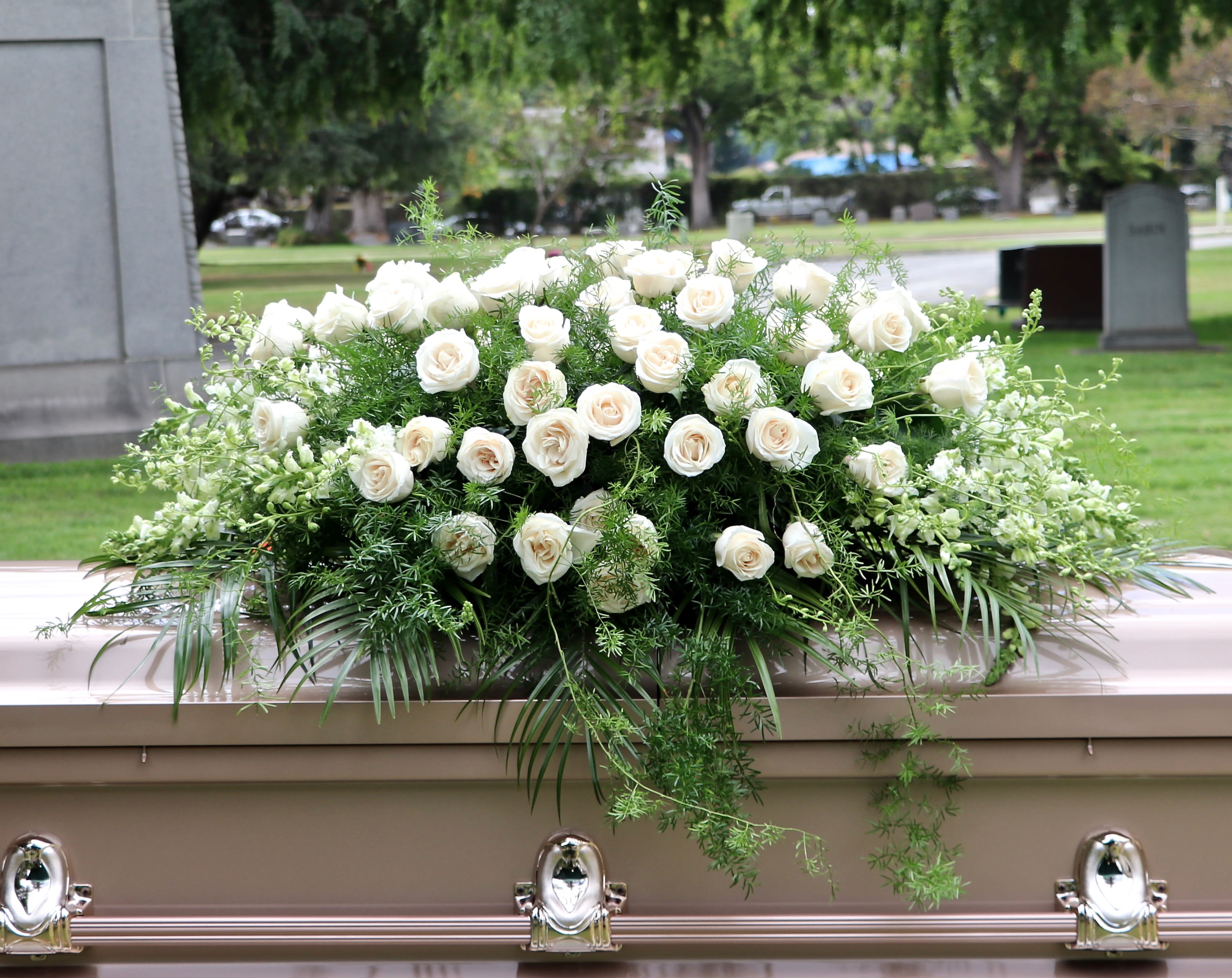 White Rose &amp; Pine Casket - Full casket spray includes white roses, snapdragons, and fragrant pines. 
