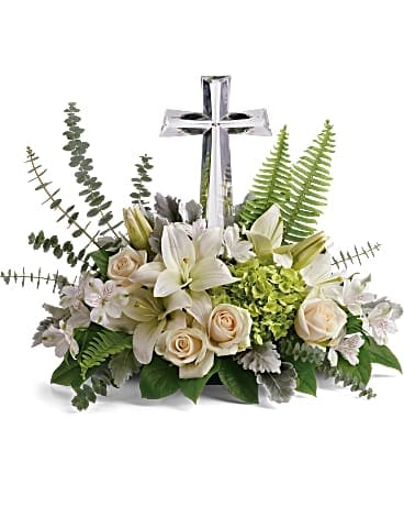 Life's Glory Bouquet by Teleflora - This peaceful bouquet of soft white flowers and green accents is a beautiful message of sympathy, adorned with a large crystal cross keepsake. Green hydrangea, crÃ¨me roses, white asiatic lilies, and white alstroemeria are accented with dusty miller, sword fern, spiral eucalyptus, and lemon leaf. Delivered with a Large Crystal Cross Keepsake.