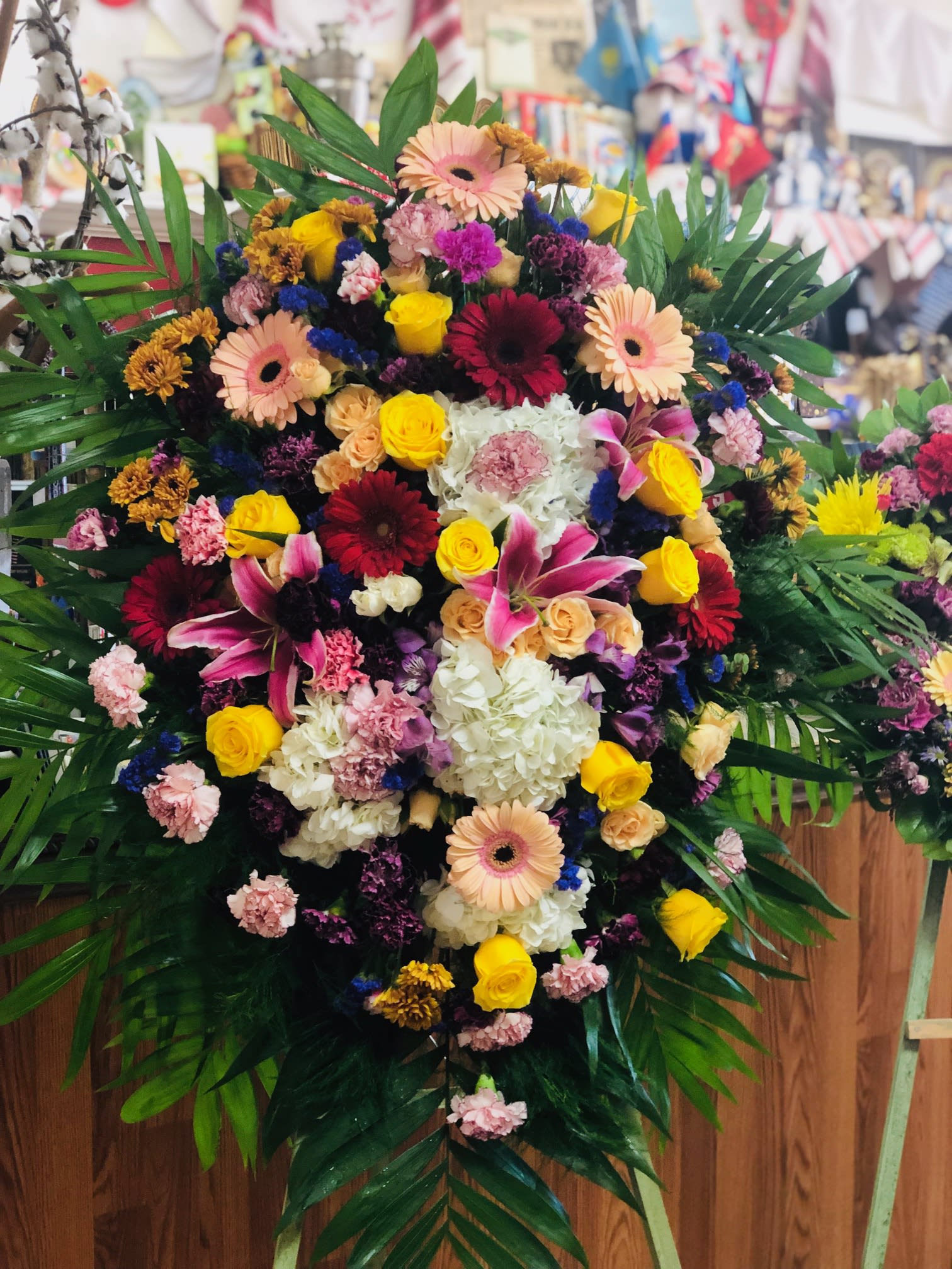Light and Bright - This bright colorful spray is beautiful and just right for an elegant expression of heartfelt sorrow and loss. Snow white hydrangeas, assorted roses, gerbera daisies, lilies and carnations. Full of light and love. 