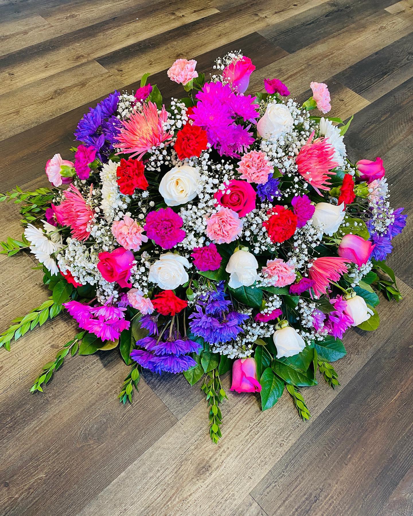Tranquility Medium Casket With Mix Flowers Tranquility Medium Casket With Mix Flowers - This is a medium casket with roses, and mix flowers.
