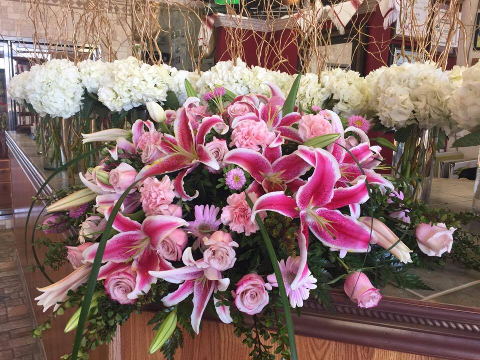 Pink Tranquility Casket Spray - The Tranquility Casket Spray is a classic design that features stargazer lilies, roses, and other pink flowers plus lush greenery. This exquisite display in shades of pink creates an elegant and beautiful display of love and sympathy. 
