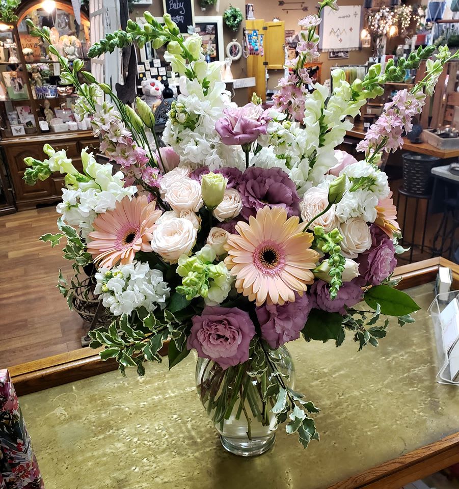 Mauves, Peaches &amp; Whites - Gerbera daisies, lisianthus, snapdragons, stock, spray roses &amp; larkspur in a clear glass vase with greenery 