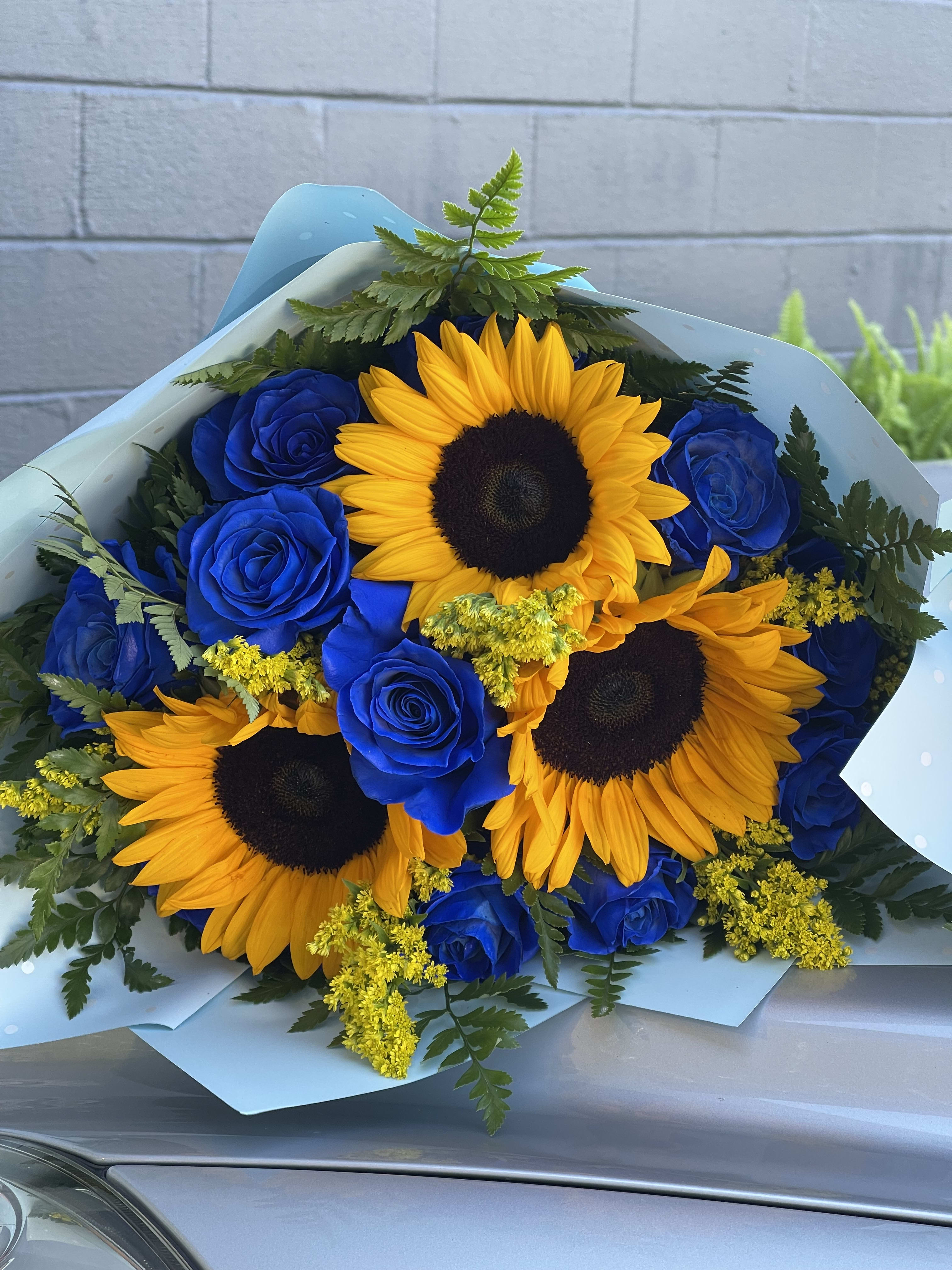 The sunflower and rose bouquet  - This handheld bouquet is created with beautiful royal blue roses and sunflower mix 