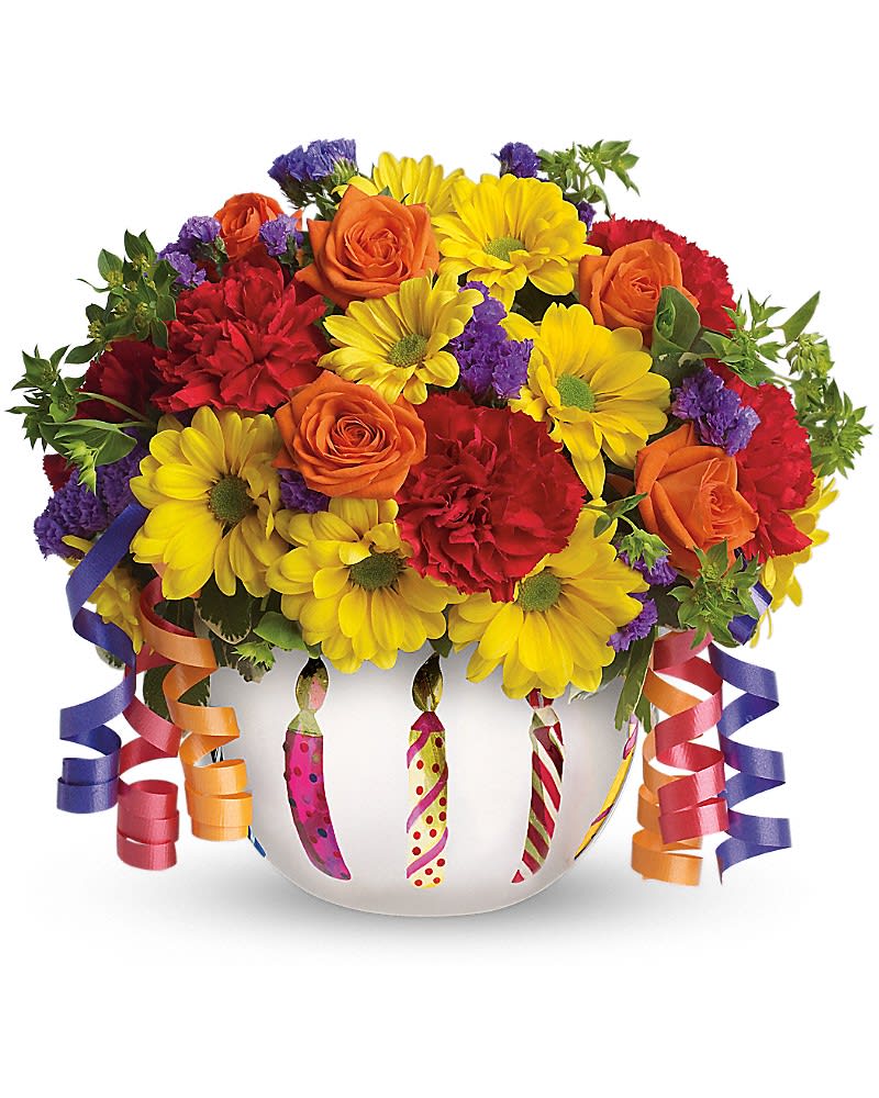 Teleflora's Brilliant Birthday Blooms - Birthday wishes can come true even before the cake is served when you send this brilliant arrangement! Bright flowers fill a frosted glass bowl that's adorned with a shiny birthday candle motif. It makes a beautiful party centerpiece and a thoughtful gift! Pretty orange spray roses, red miniature carnations, yellow daisy spray chrysanthemums, purple statice and more are joined by yards of curling ribbon and delivered in a very special keepsake container. Brilliant? You bet!