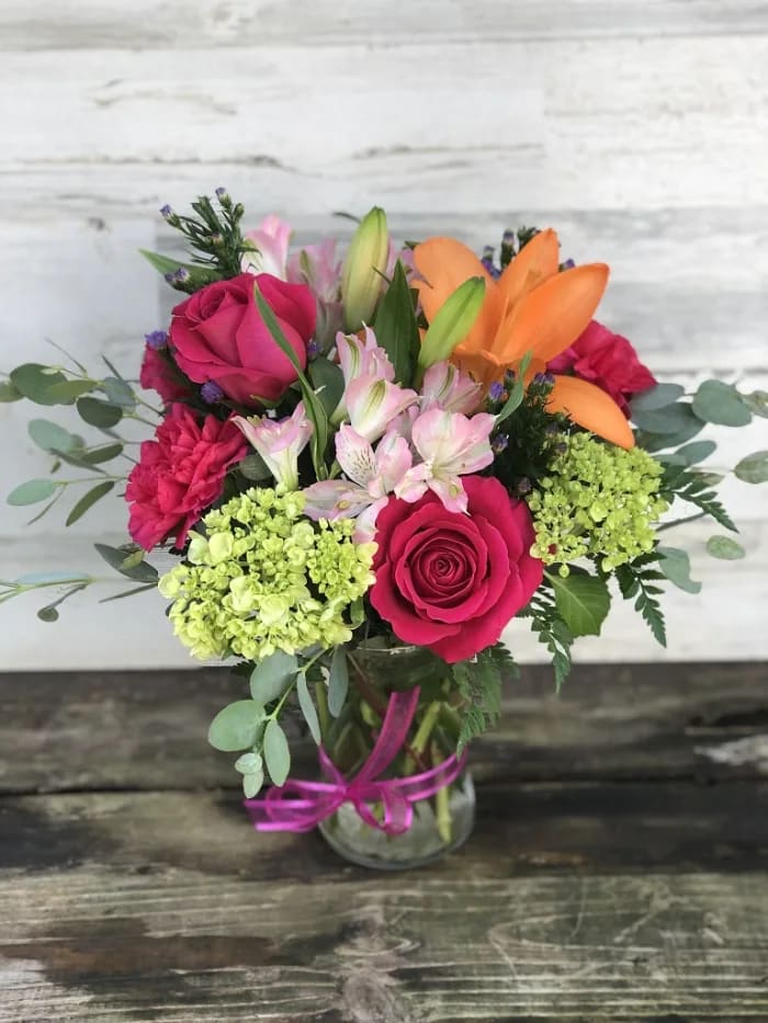 Summer Lovin' - Embrace the feelings of summer lovin' when you send this vibrant-colored arrangement. If you can’t be there to give a hug in person, this bright bouquet is the next best thing! From the freshest lilies, roses, and alstroemeria, its beauty and charm will help you express yourself perfectly, no matter the occasion.