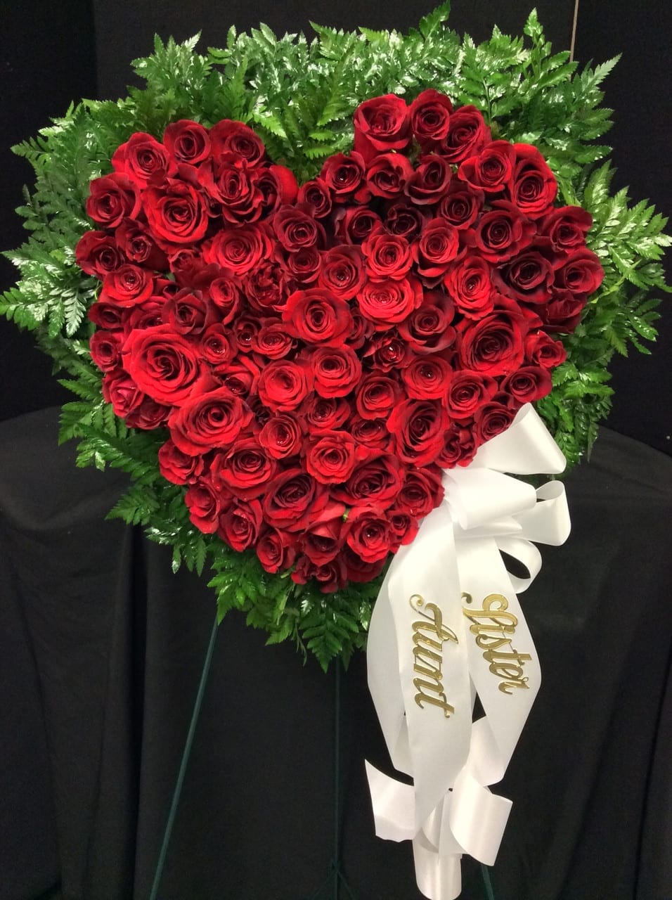 Heartfelt Goodbyes Heartfelt Goodbyes - This exquisite heart-shaped wreath is made with lush, full red roses and delicate leather leaf to create an elegant, memorial arrangement. A white satin ribbon adds a final, beautiful touch that will honor and celebrate the life of a loved one.