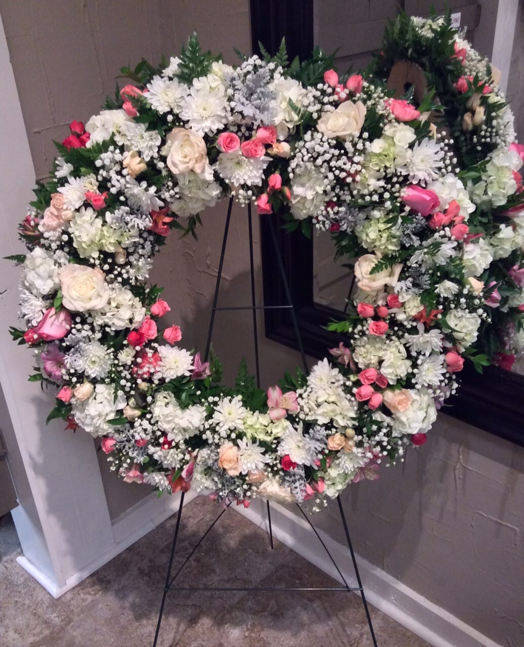 Sweet Journey Wreath Sweet Journey Wreath - This breathtaking serenity wreath honors the passing of a loved one. The delicate, beautiful design contains an array of soft and soothing pastel hues, including cream and white roses, pink spray roses, white hydrangea, pink alstroemeria, and baby's breath. The blend of soft colors beautifully honors the memory of your loved one and will provide lasting comfort.