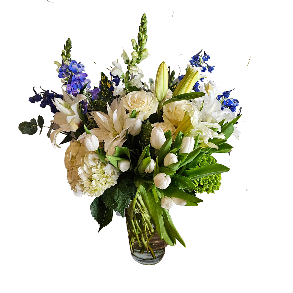 Whimsical Winter Blooms: A Grand Floral Statement Whimsical Winter Blooms: A Grand Floral Statement - Whimsical Winter Blooms: A Grand Floral Statement Step into a winter wonderland every time you gaze upon our grand floral arrangement, perfectly capturing the essence of the season's pristine beauty. Standing impressively at 3 feet tall and spanning 2 feet wide, this masterpiece is more than just a flower arrangement—it's a statement. Highlights: Colors: A symphony of pure whites with gentle hints of frosty blue, encapsulating the serene and tranquil ambience of winter. Oriental Fragrant Lilies: The star of the arrangement, these lilies exude a delicate fragrance that fills the room, reminiscent of winter evenings by the fireplace. Hydrangea: These lush blooms add depth and volume, beautifully complementing the tall and elegant lilies. Tulips: A symbol of perfect love, our winter tulips are a gentle nod to the promise of spring. Cabbage Roses: These unique and voluptuous roses bring a touch of unexpected charm, adding to the richness of the ensemble. Eucalyptus: Fresh and aromatic, the eucalyptus not only adds a touch of greenery but also a calming scent that's perfect for those chilly winter days. Curly Willow Branches: Cascading whimsically, they add height and an organic, wild touch to the arrangement, mimicking the bare trees of winter. This luxurious arrangement is more than just a visual treat—it's a multi-sensory experience. Whether placed in a grand foyer, a dining room centerpiece, or as the focal point in a living area, it promises to turn heads and warm hearts. Gift it to someone special or make it the centerpiece of your own holiday decor. Our Whimsical Winter Blooms promises to bring the magic of the season right into your space.