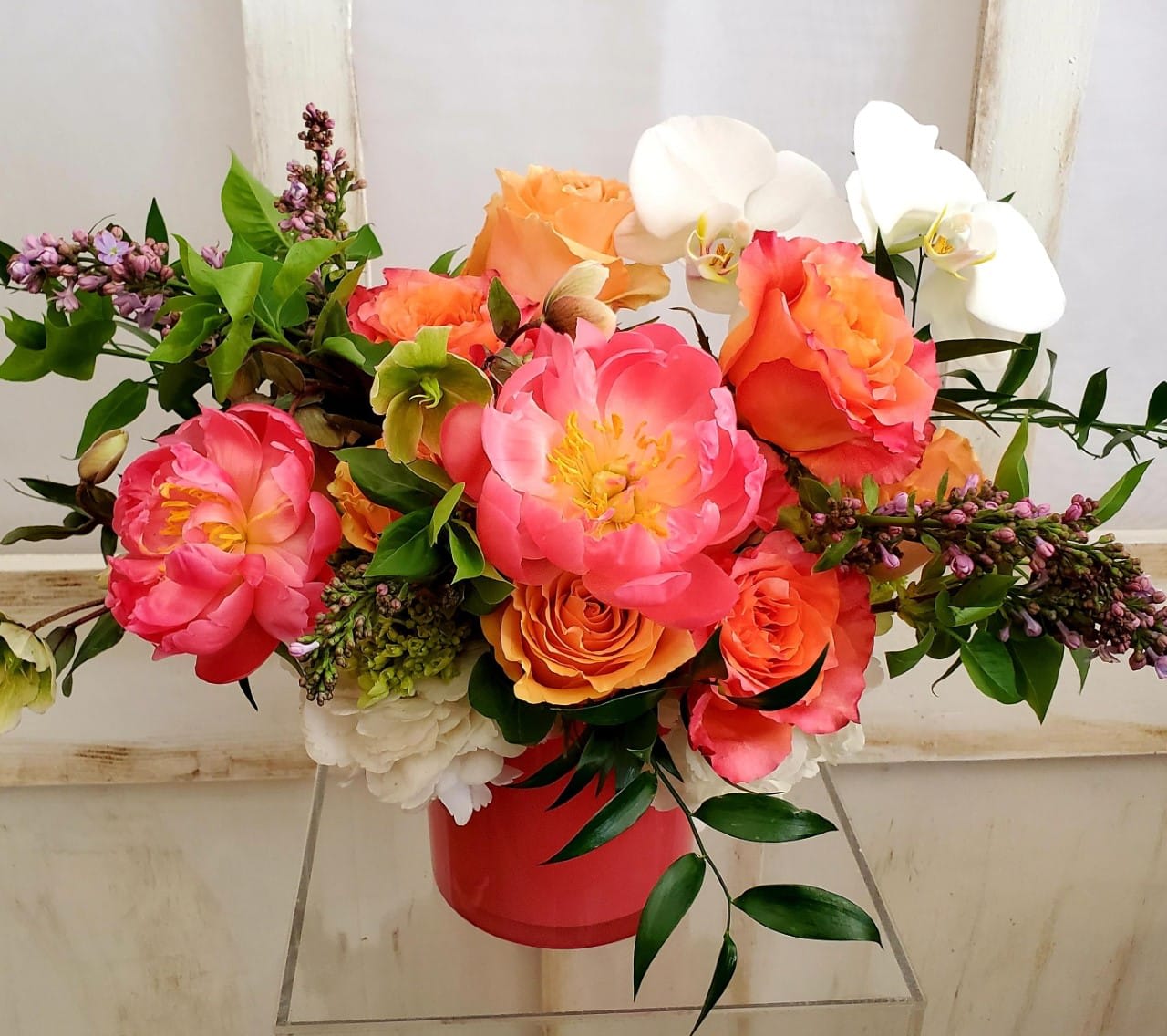 Hot (Mess) Mama Hot (Mess) Mama - Pretty sure the name says it all for this showstopper! We all know "that mom" (me, I'm that mom) that needs a hug, a beach, a drink, a doggie kiss, a massage and ... some flowers! This gem has all the favorites of the season! Peonies, orchids, lilac, hydrangea and garden roses!