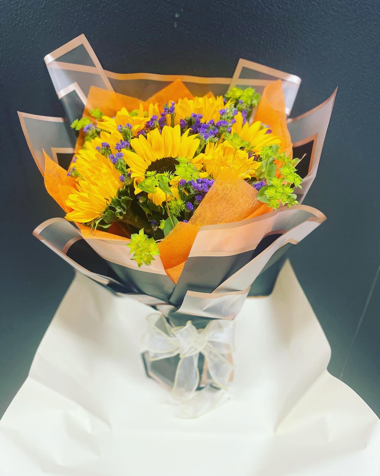 From The Heart Bouquet 10 From The Heart Bouquet 10 - This Bouquet made with sun flowers , Static and Alchemilla mollies, finish with black and orange wrapping . you can let us know what color wrapping you like to wrap this bouquet .
