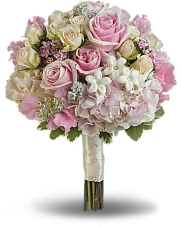 Pink Rose Splendor Bouquet - A wonderfully wide variety of soft pink and white blooms make this fragrant bouquet fabulously feminine. Sensational stems of pink hydrangea, light pink roses, crÃ¨me roses, pink sweet pea, pink bouvardia, stephanotis and dusty miller are contrasted against variegated pittosporum.