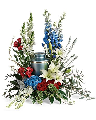Reflections Of Honor Cremation Tribute - Proud and patriotic, this boldly designed red, white and blue bouquet displays the cremation urn with honor. This patriotic tribute includes blue hydrangea, white dendrobium orchids, red roses, white asiatic lilies, red alstroemeria, red carnations, blue delphinium, white snapdragons, dusty miller, myrtle, huckleberry, variegated ivy, curly willow, aralia leaves, parvifolia eucalyptus, spiral eucalyptus, and lemon leaf. Arrangement does not include urn.