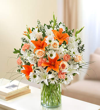 Sincerest Sorrow - Peach, Orange and White Sincerest Sorrow - Peach, Orange and White - Express your sorrow with a memorable tribute: our bright and beautiful arrangement of lilies, roses, gladiolas, stock, daisy poms and more. Awash in soothing shades of peach, orange and white, it's hand-crafted by our florists in a classic vase for the home or service. Lush peach, orange and white arrangement of roses, lilies, gladiolas, stock, daisy poms, carnations and monte casino, accented with variegated pittosporum, salal, myrtle and bear grass