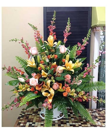 Warm Memories Warm Memories - Sympathy basket filled with Liles, Snap Dragons, Roses, Alsrtomeria, Spray Roses and calla liles. All flowers and colors are subject to change due to availability. FCF-0098