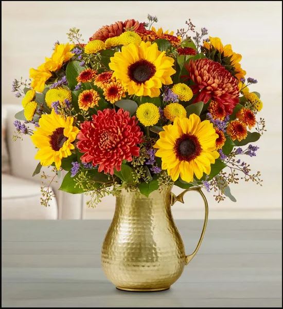 Sweet Sunset Bouquet - Send a burst of fall with our garden style bouquet. Hand designed in rich autumn hues, it’s gathered in our gently hammered golden pitcher, bringing the heart of harvest style to any space.