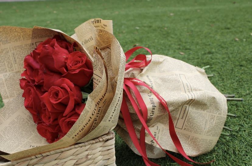 Dozen red roses newspaper  - 12 red Roses  wrapped in newspaper  Glass vase not included