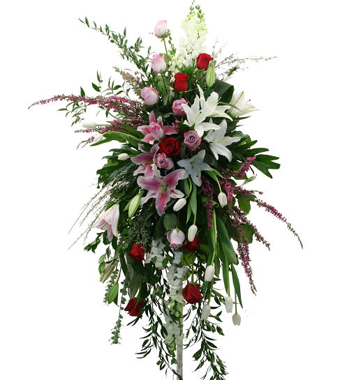 Paradise  standing spray  - The exotic foliage in this beautiful standing spray offers the feeling of the tropics. Flowers in red, white and shades of pink add perfectly to the true beauty of this artful design.
