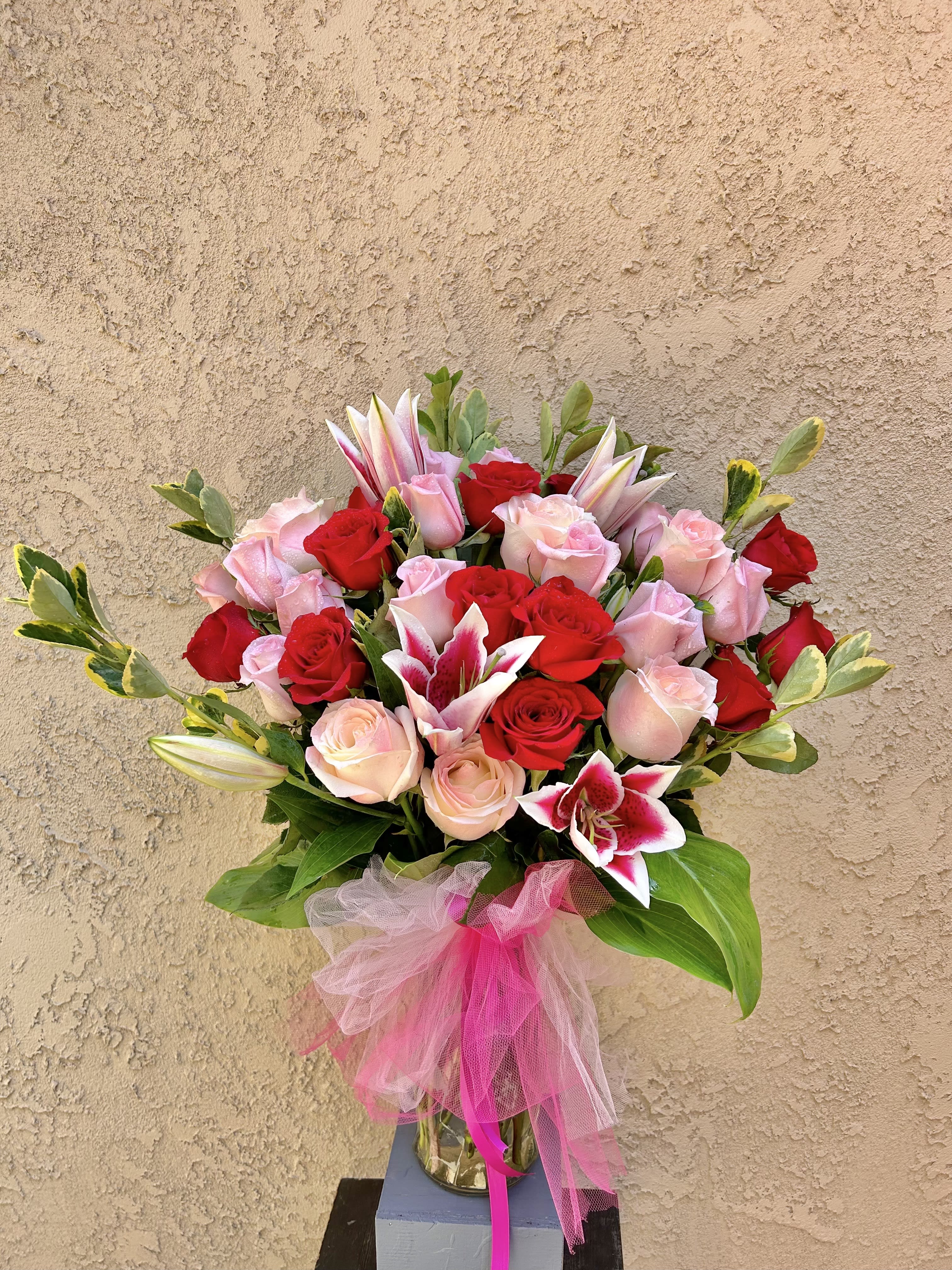 Velvet  - Beautiful arrangement featuring red and pink roses with pink lilies and green accents