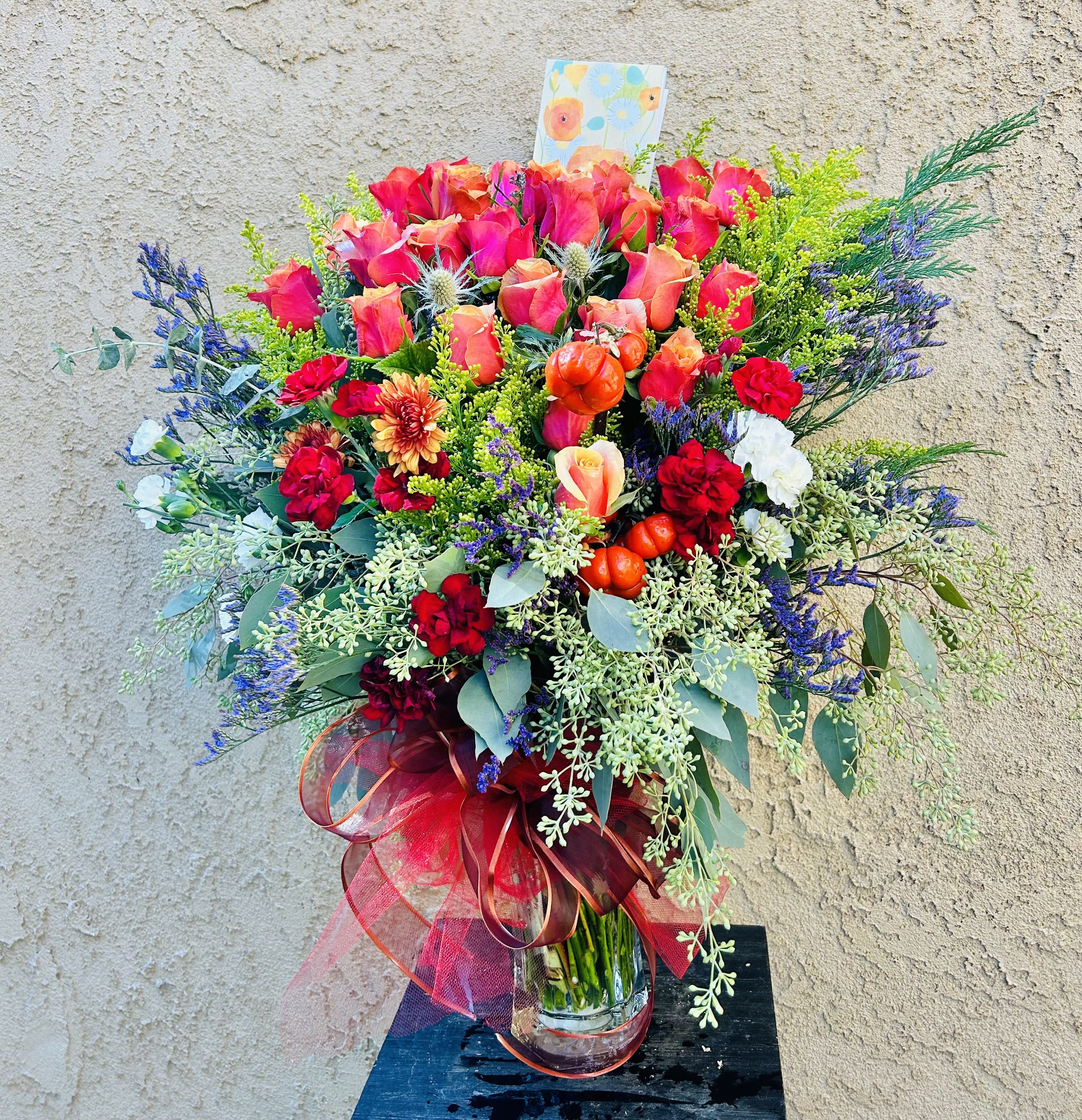 Vibrant Life - Beautiful arrangment featuring coral roses, carnations, chrysanthemums, and accents.