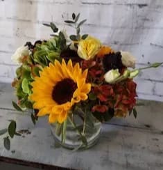 Sunrise & Shine Sunrise & Shine - Sunrise and shine with this beautiful floral display sure to brighten your day. Beautifully accented with cheerful sunflowers, hydrangea, spray roses and eucalyptus.