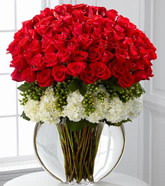Lavish Luxury Rose Bouquet - Lavish your special someone with a bouquet that will leave them breathless. Silky red 24-inch premium long-stemmed roses offer a message of passionate love and affection arranged amongst a bed of white hydrangea blooms elegantly accented with clusters of green hypericum berries. Arriving in a superior clear glass pillow vase, this luxurious bouquet will leave a lasting impression. Stands approximately 33-inches in height.