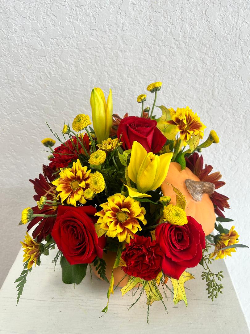 CFF122 - An orange ceramic pumpkin designed with a beautiful fall tone floral mixture such as roses, mums and others.  