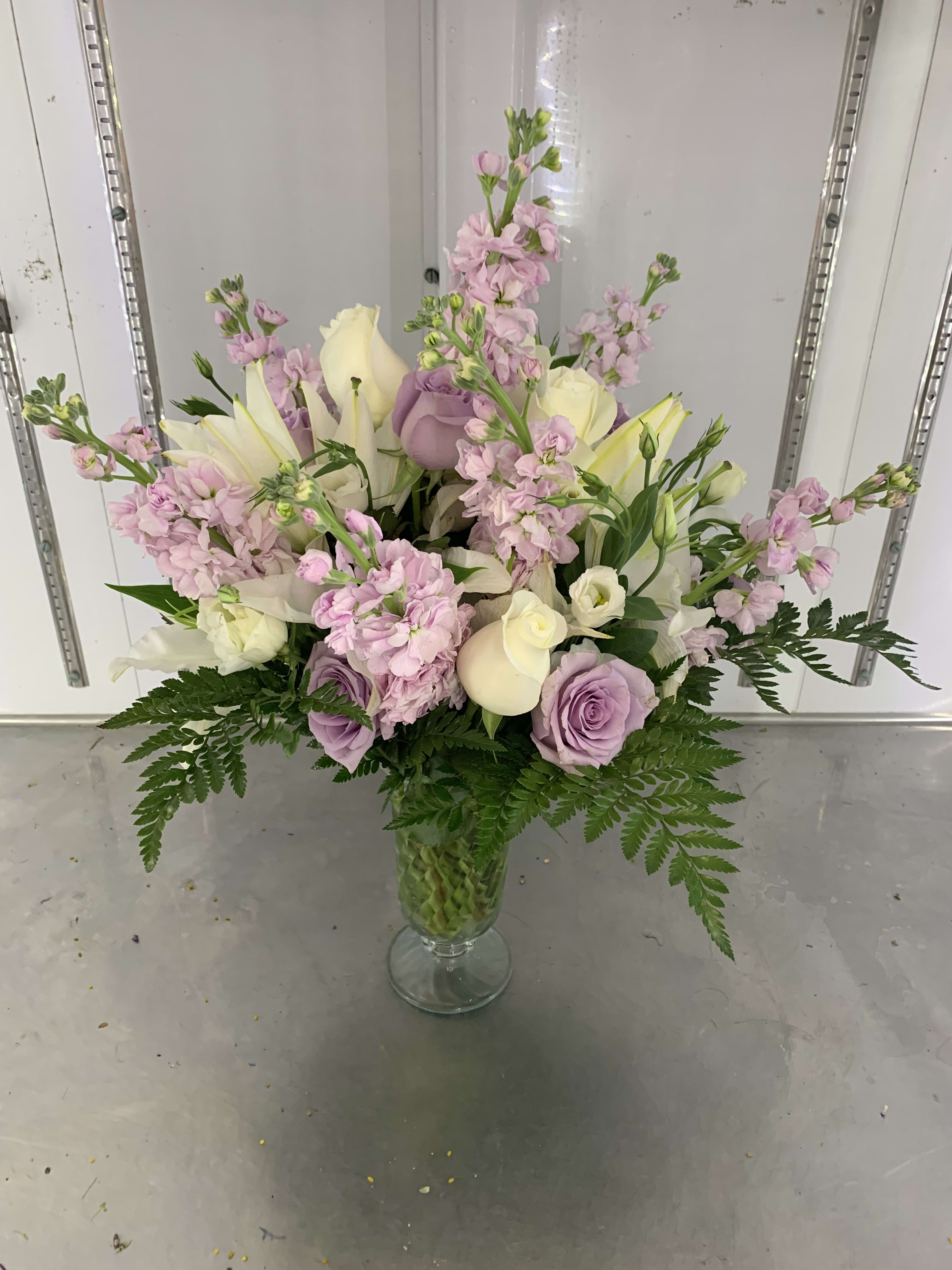 ANN'S LAVENDER DREAM - 6 WHITE ROSES 10 LAVENDER ROSES 3 WHITE LILIES 6 PINK STOCK 5 WHITE LISIANTHUS AND LEATHER