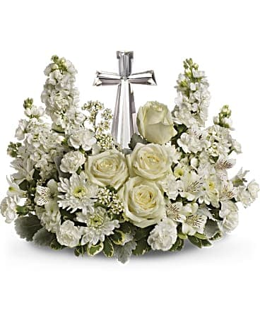 Teleflora's Crystal Cross - An elegant display of faith and divine peace, this beautiful arrangement will comfort the bereaved in a truly thoughtful and respectful way. An exquisite crystal cross is surrounded by a bed of lovely blossoms. It is sure to be appreciated and always remembered. •	A fragrant mix of pure white blooms - including roses, alstroemeria, stock, carnations and waxflower - is accented with variegated pittosporum around an exclusive Crystal Cross keepsake. •	Orientation: One-Sided 