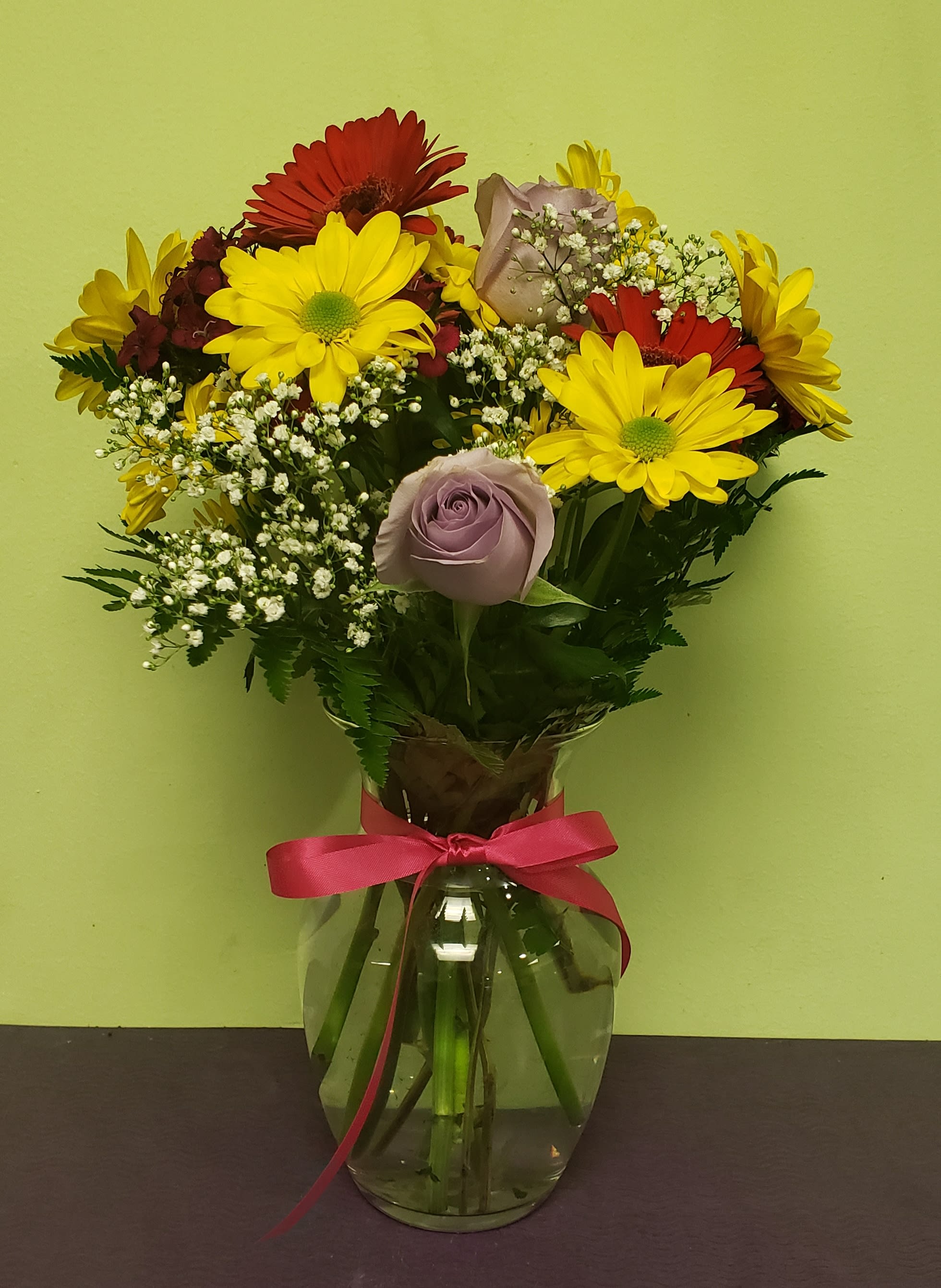 Hot Spring! - A great arrangement that is full of fun and color. Enjoy a beautiful arrangement full of Daisies, Roses and more!