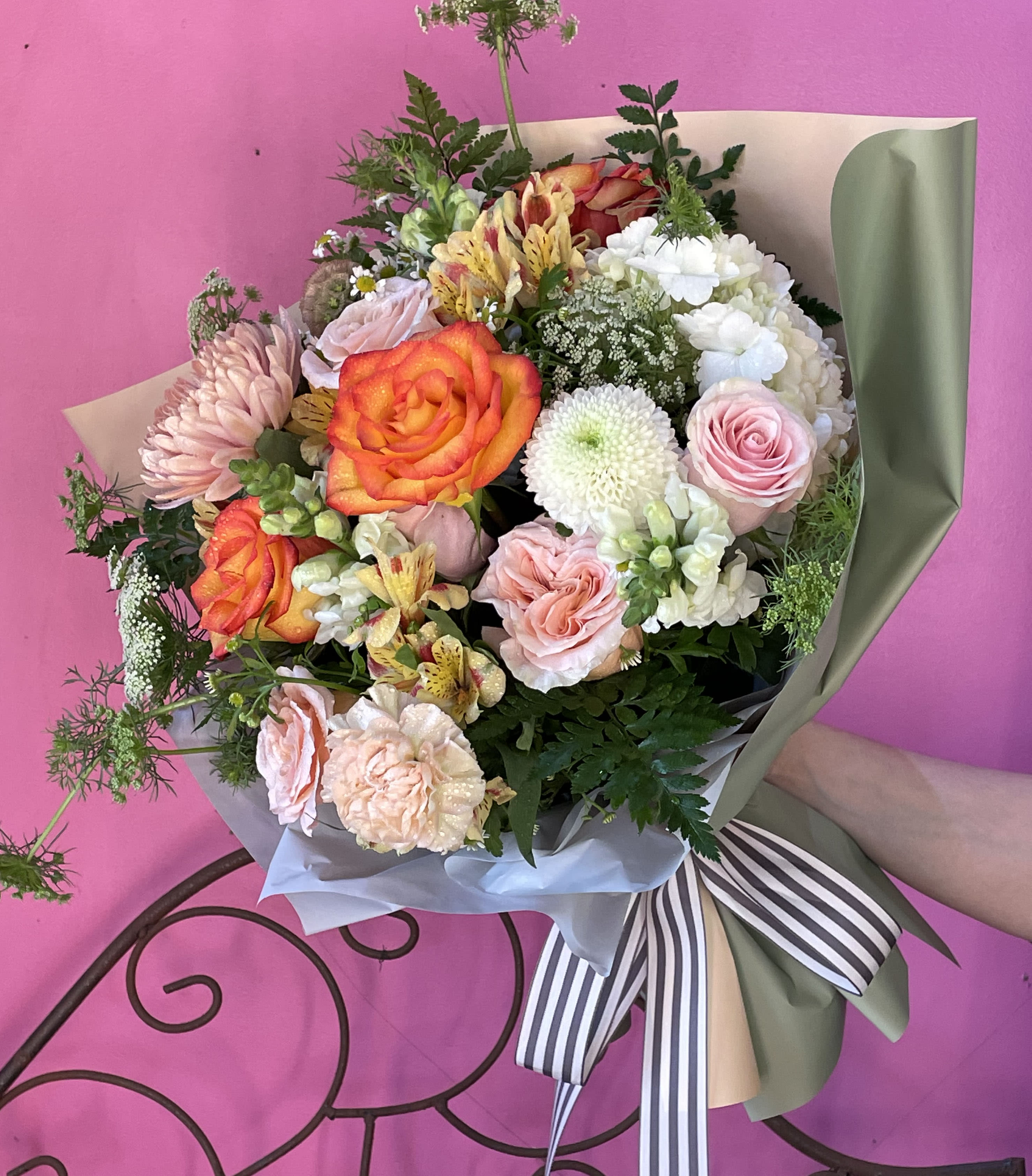 Sage and Cream Bouquet  - A creamy mix of orange, white, and greens! A perfect gift to add a little color to life! Wrapped in our unique sage paper with a grey and white stripe bow, perfect to show that special someone you care!  