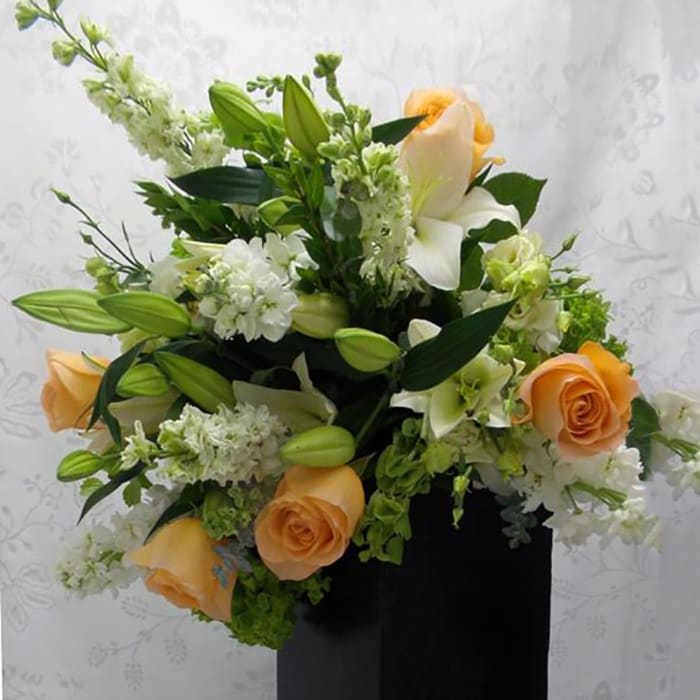 Two Sorbete - Another version of this delightful hand-tied bouquet. Peach roses, white Asiatic lilies, lisianthus, stocks, larkspur, eucalyptus, and green hydrangeas.  
