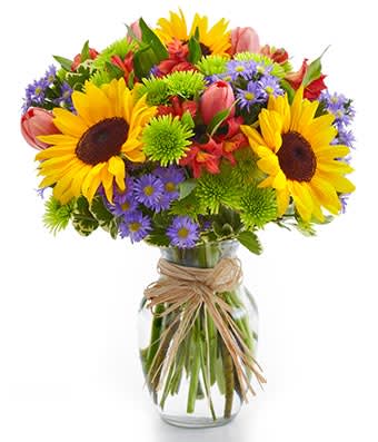 European Garden Bouquet - The essence of Europe comes to life in all its grandeur with this bright assortment of alstroemeria, button poms, Monte casino, sunflowers and tulips in an elegant clear glass vase. Measures 12&quot;H by 10&quot;L.