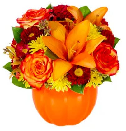 Harvest Pumpkin - Nothing says Fall like pumpkins, so brighten someone's day with the Harvest Pumpkin bouquet. This pumpkin, filled with orange lilies and roses, red matsumoto asters, and yellow poms, surrounded by greenery, is the perfect decoration for fall! Delivered in a ceramic pumpkin container, this bouquet is the perfect gift for Halloween or the fall season.
