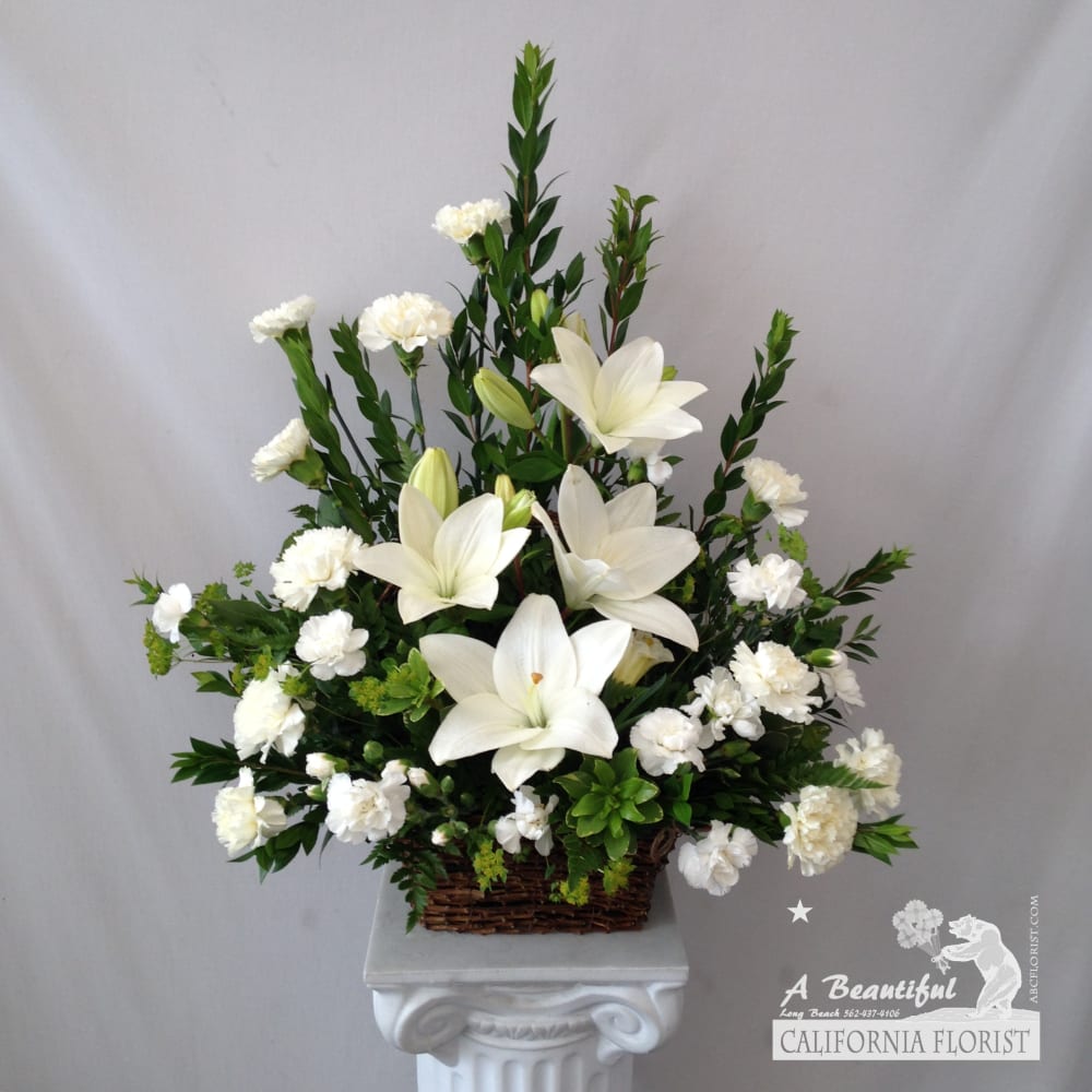 Fond Farewell - Bid a Fond Farewell with this beautiful arrangement of Lilies, Carnations and lush accent greens, arranged in a basket. This arrangement is appropriate for sending to the home, office or memorial service. Fond Farewell from A Beautiful California Florist, offering same day and expedited sympathy and funeral flower arrangements and delivery to Long Beach and surrounding cities.  