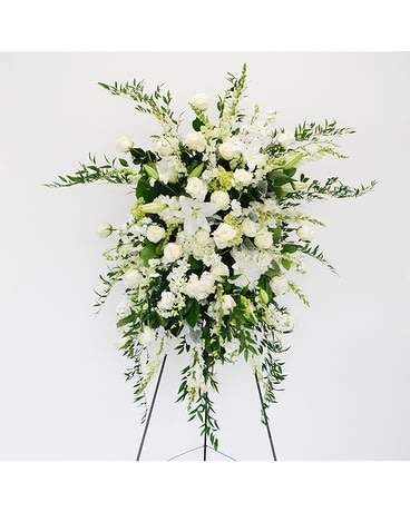 Serenity Standing Easel Spray - This incredible spray from the Serenity Collection are lush with fragrant white lilies and stock, snapdragons, orchids, roses, white hydrangeas, ruscus and lemon leaf foliage.