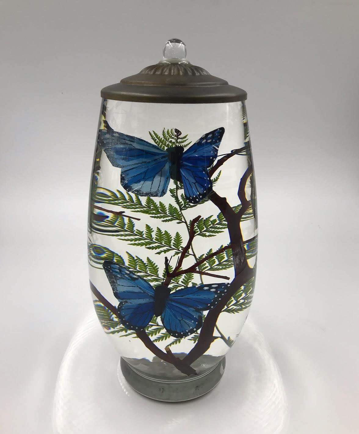 Brandy Lifetime Candle - Butterfly - This clean burning candle showcases two butterflies and makes a beautiful display even when it's not burning.  Candles comes complete with a fiberglass wick that never needs replaced and lasts year after year.    **Butterfly color based on availability - Blue, Orange or Purple  Lifetime Oil Candles are Refillable, Smokeless, Odorless and Handcrafted in the U.S.A. Burn Time Approx. 4 hours for every 1 oz.oil (Varies by Design &amp; Wick Length)