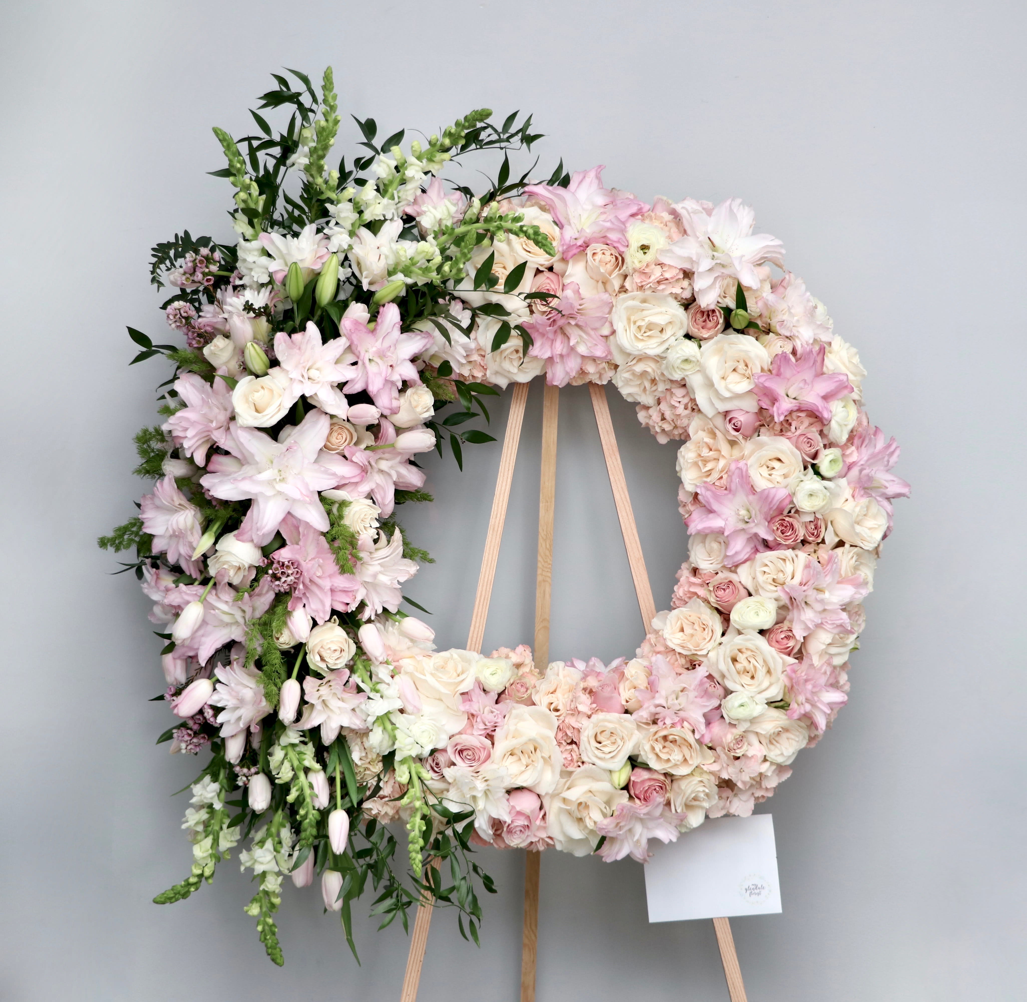 Blushy Wreath  - Blush colored florals to fill this wreath.  We include easel, printed banner and delivery (some fees may apply).  Standard size is 30'', deluxe is 36'', and premium is 42''.