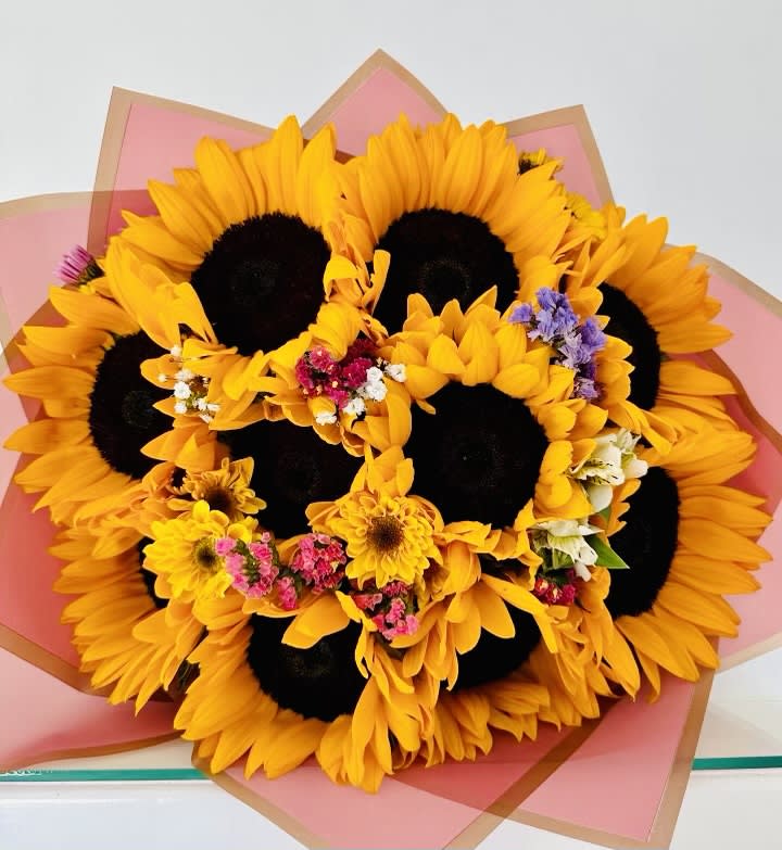 Hand Wrapped Sunflower Bouquet Hand Wrapped Sunflower Bouquet - Hand wrapped sunflowers in wrapping paper