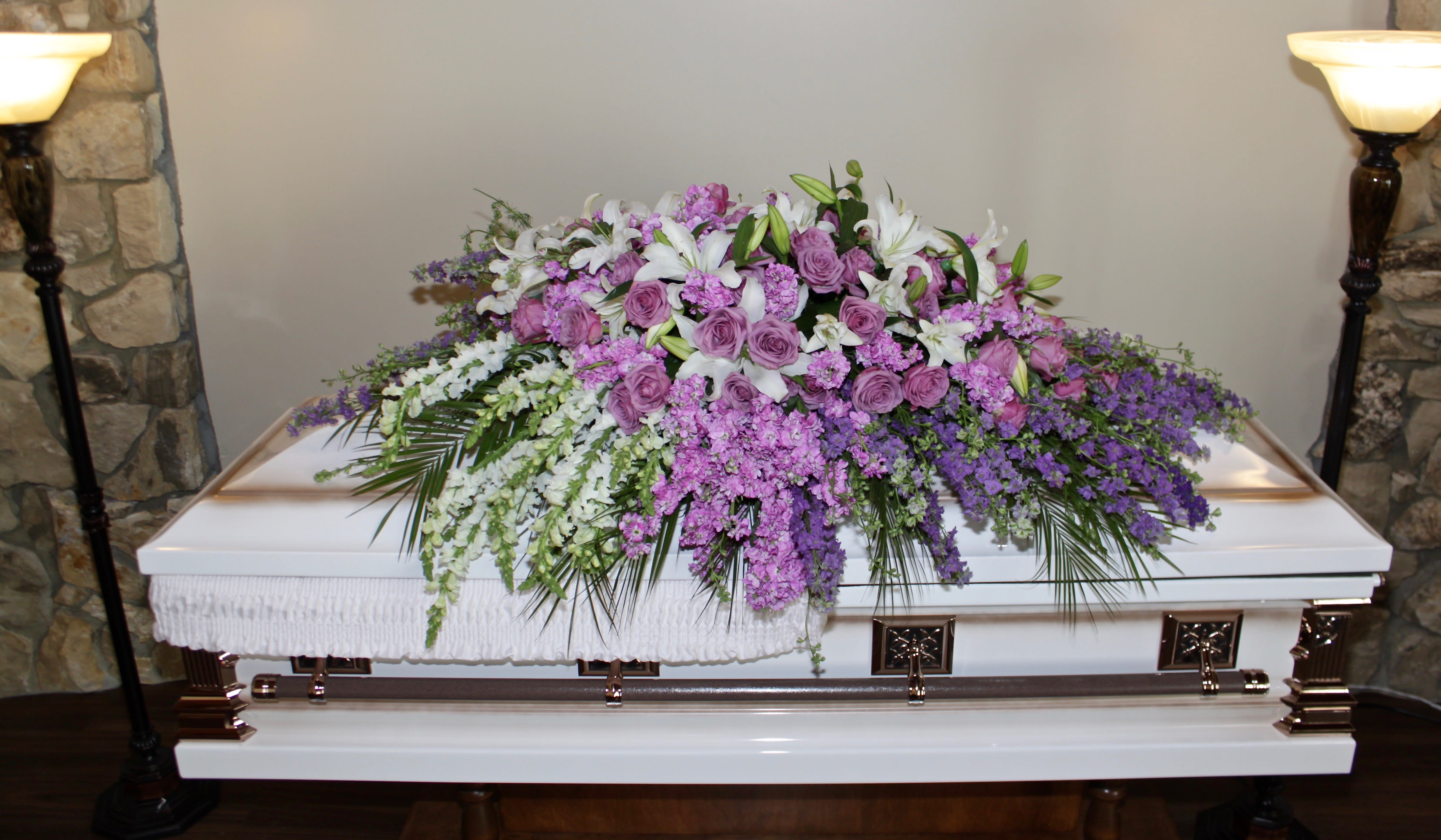 Lavender Rose Casket - My Glendale Florist - This casket arrangement contains several different shades of lavender florals. 
