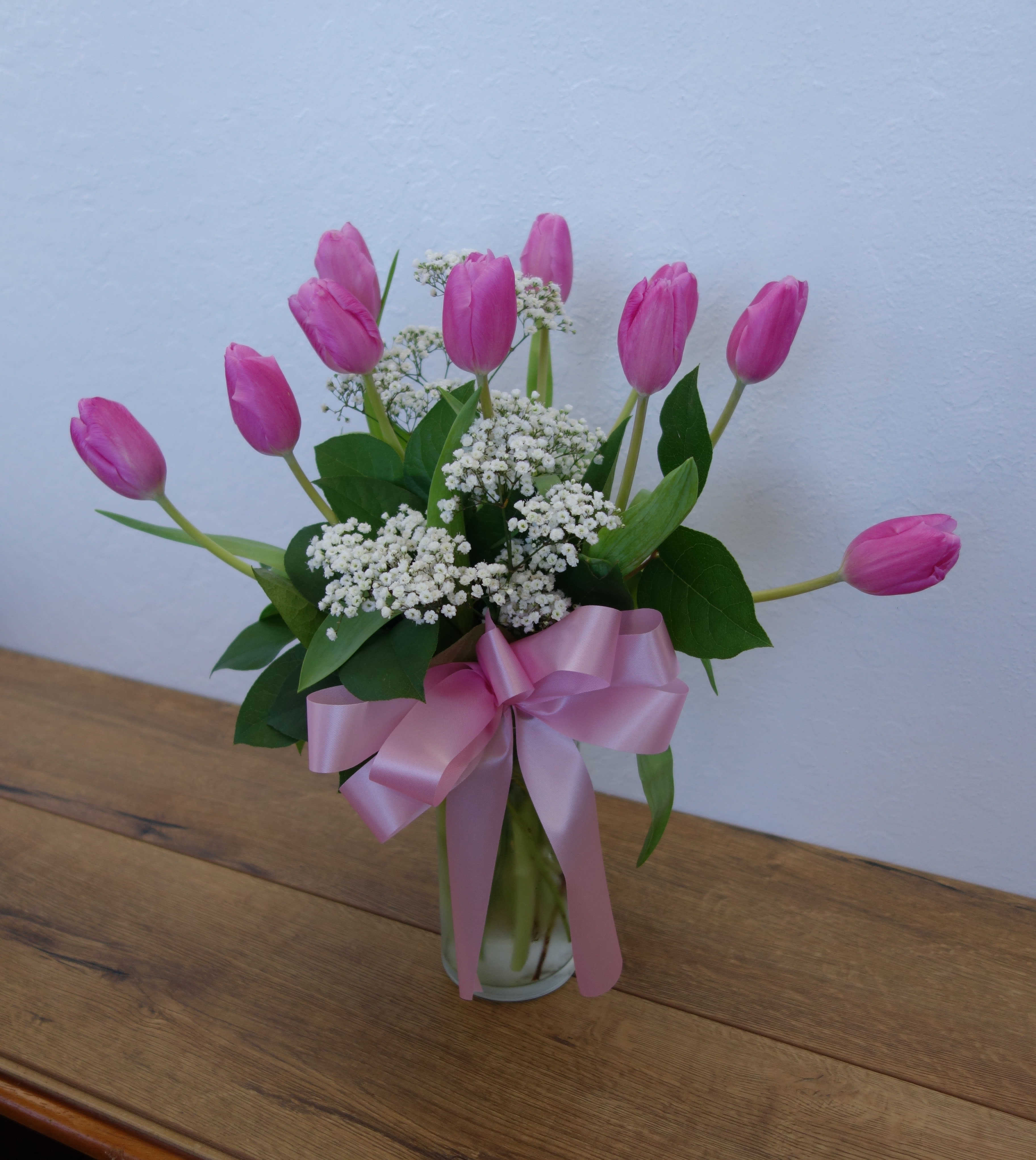 Precious Pink Tulips - Beautiful and &quot;simply said&quot; light pink tulips are a hip way to show you care. Delicate light pink Tulips arranged in a clear glass vase.  Orientation: All-Around  As Shown : 10 stems Deluxe : 20 stems Premium : 30 stems