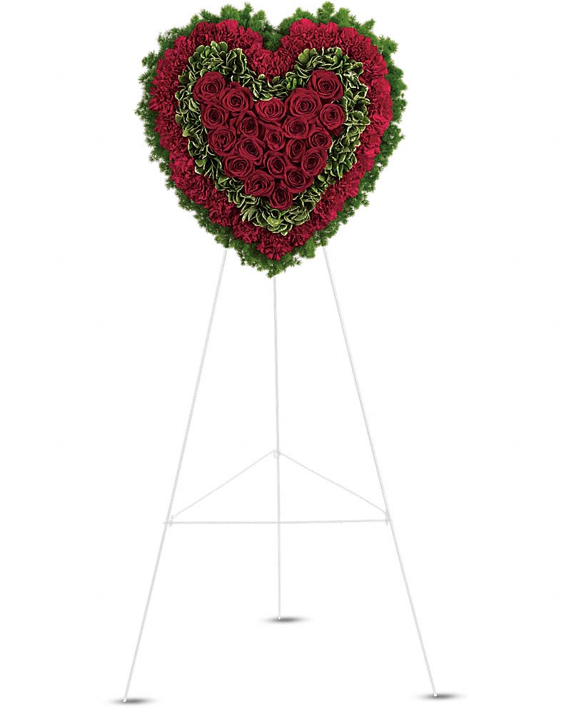 Majestic Heart - Remember a loved one's generous heart with this red arrangement in a classic heart shape a declaration of eternal love and devotion. Solid red roses matched with deep red carnations are surrounded by variegated greens and fern.