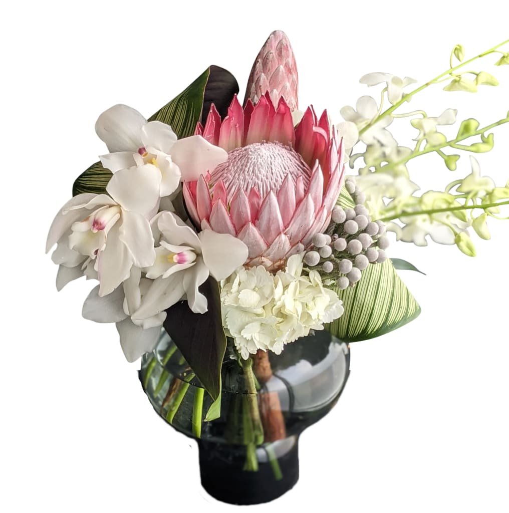 Pink and White Tropica - King protea, exotic tropical foliages, orchids and others create this unique design in our smolke sexy vase 