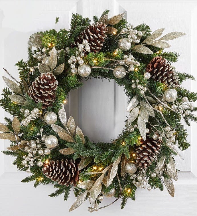QWinter Splendor Metallic Wreath-24&quot; - Our winter-themed wreath is a celebration of the season’s splendid beauty. Crafted from a base of authentic faux greenery, it’s blended with metallic-tipped pinecones, silvery leaves and other glimmering accents. Classic white lights add warmth and style, creating a stunning display for all to enjoy.