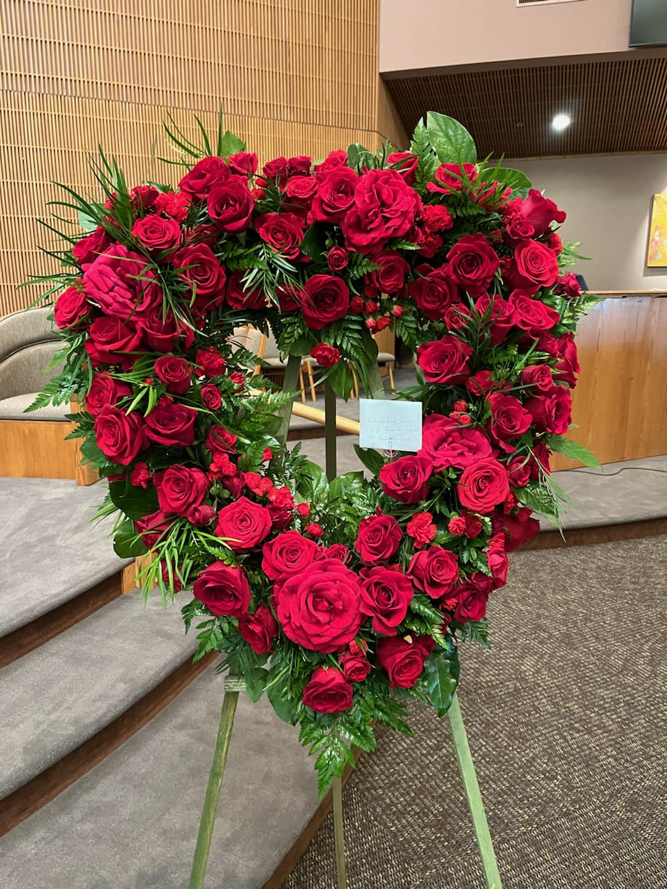 Red Rose Open Heart - A red heart on a stand made up of different sizes of Red Roses and a selection of greenery. 