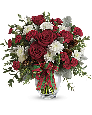 Holidays Holidays - This bold bouquet includes red roses, red carnations, red miniature carnations, white cushion spray chrysanthemums, flat cedar, noble fir, dusty miller, parvifolia eucalyptus, small pinecones and wired ribbon.